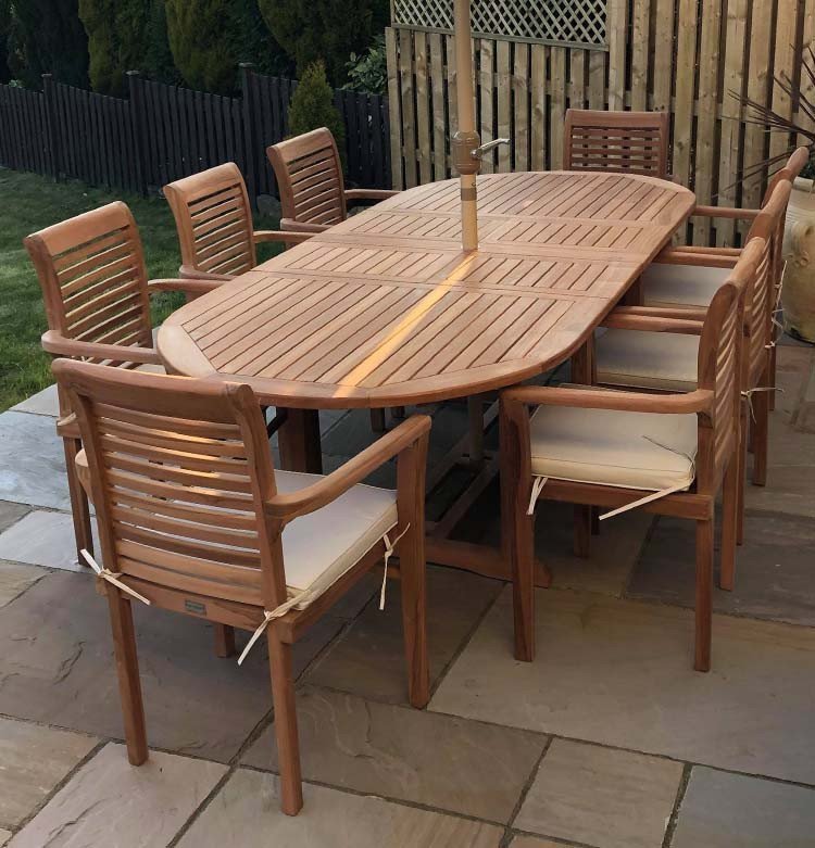 Double extendable table 1.8m to 2.4m, 8 x teak stacking chairs, free 3m parasol and cushions