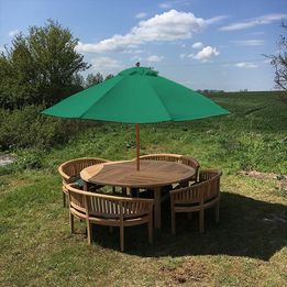 Teak garden dining table. 1.8m Titan round table with 4 bow wood style seats
