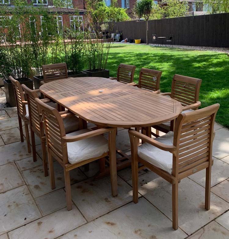Double extendable table 1.8m to 2.4m, 8 x teak stacking chairs, free 3m parasol and cushions